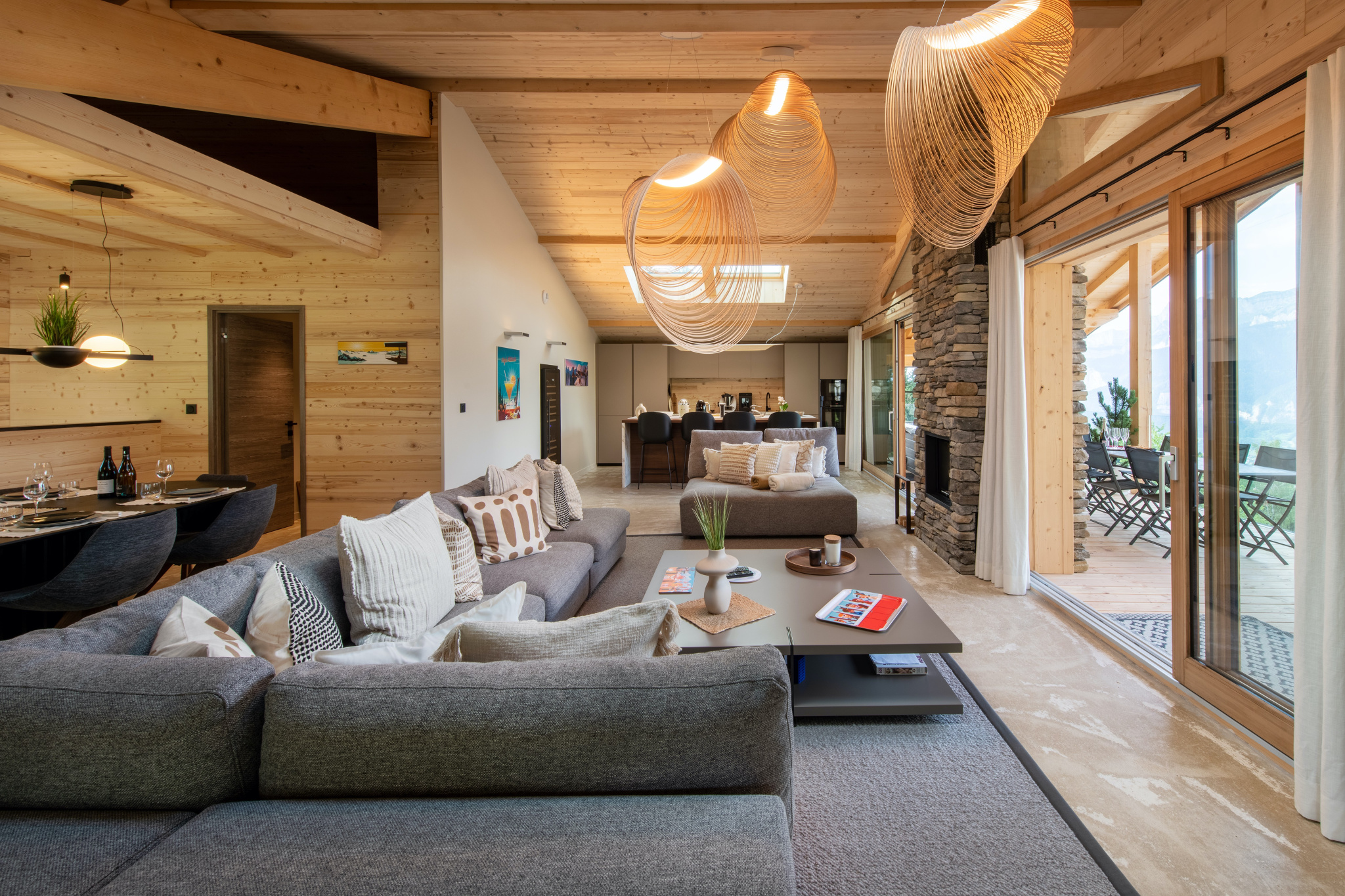 Séjour principal avec lustres design et vue montagne
